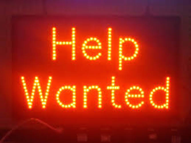 A red sign that says help wanted