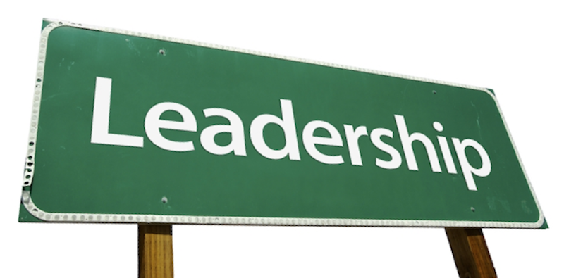 A green street sign with the word leadership written on it.