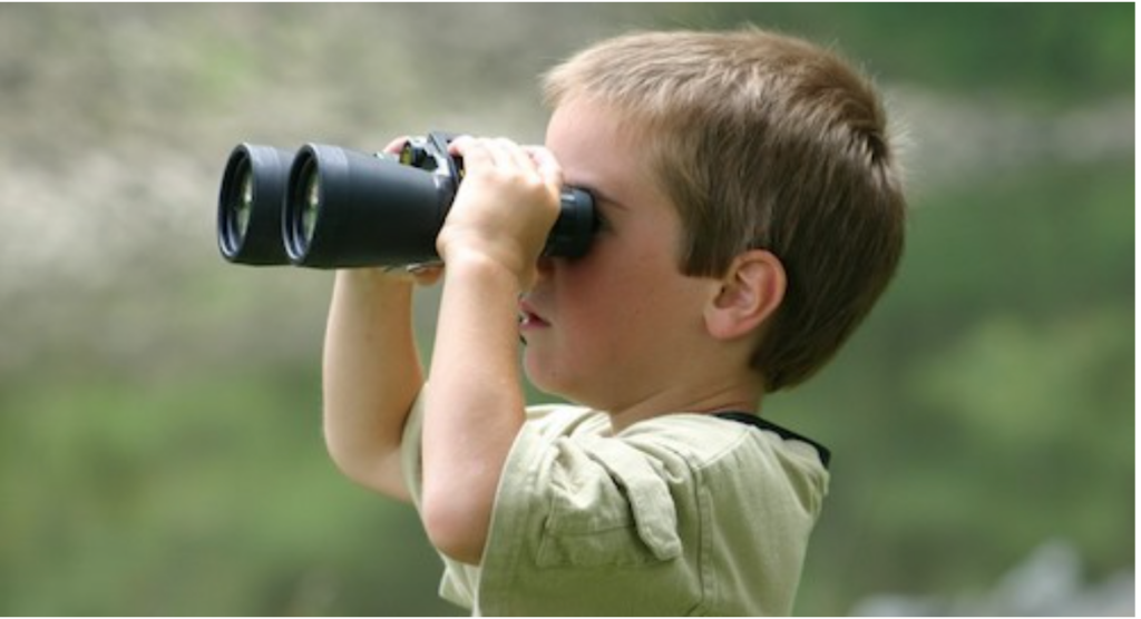 A child using binoculars