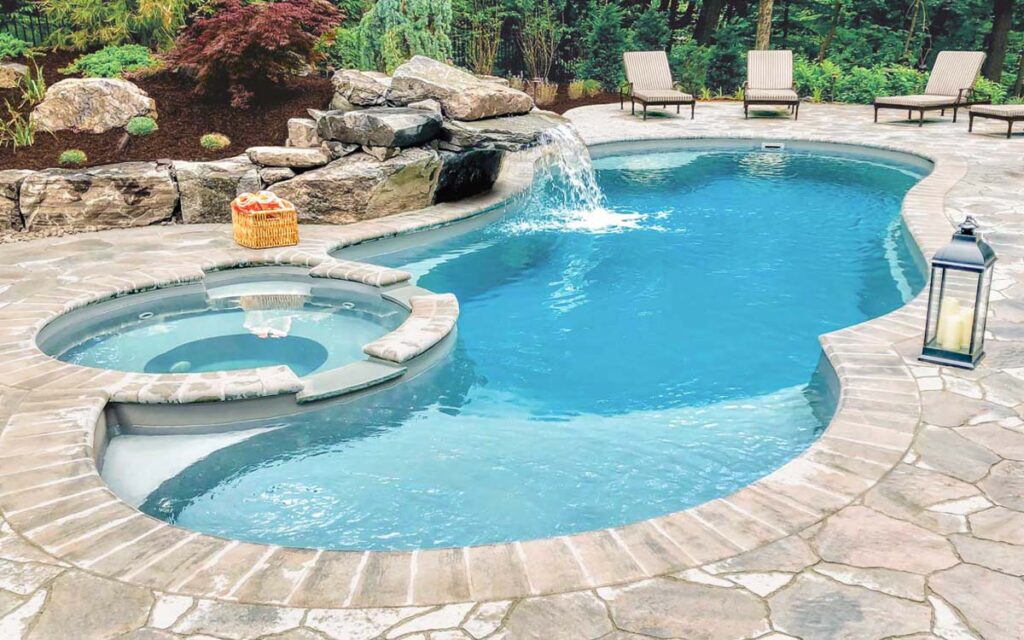 Backyard pool with waterfall and spa.