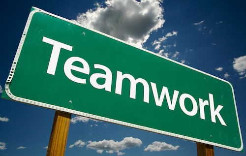Green signboard with the word "Teamwork.