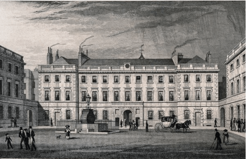 Historical building with people and horse carriage.