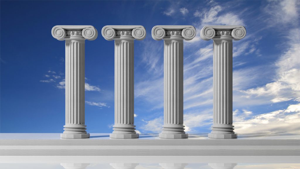 Four classical columns against a cloudy sky.