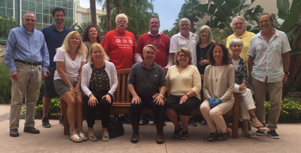 Group photo of people sitting and standing.