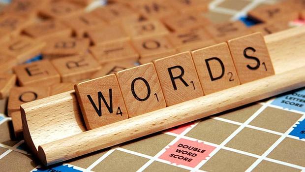 Scrabble tiles spelling "WORDS" on board.