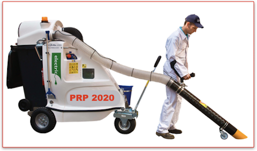 Person operating industrial vacuum cleaning machine.