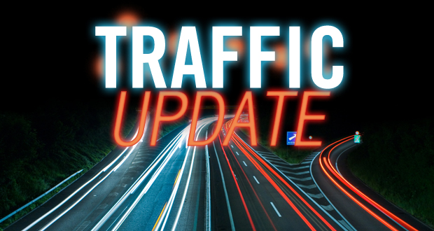 Traffic update text over highway lights.