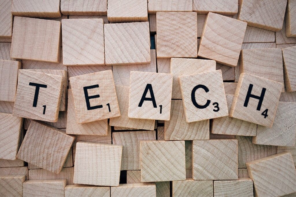 A pile of wooden blocks with the word peace spelled out in scrabble tiles.