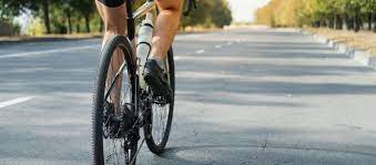 A person riding a bike on the side of a road.