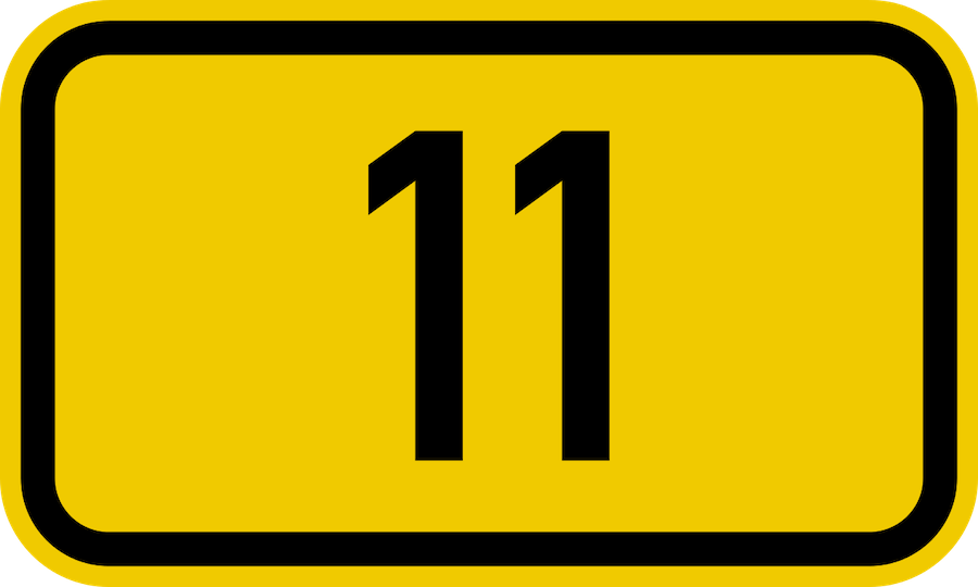 A yellow sign with the number eleven in black.