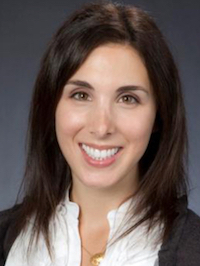 Smiling woman with dark hair, formal attire.