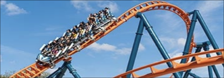 People riding a roller coaster loop.