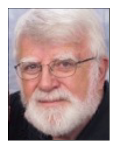 Elderly man with white beard and glasses.