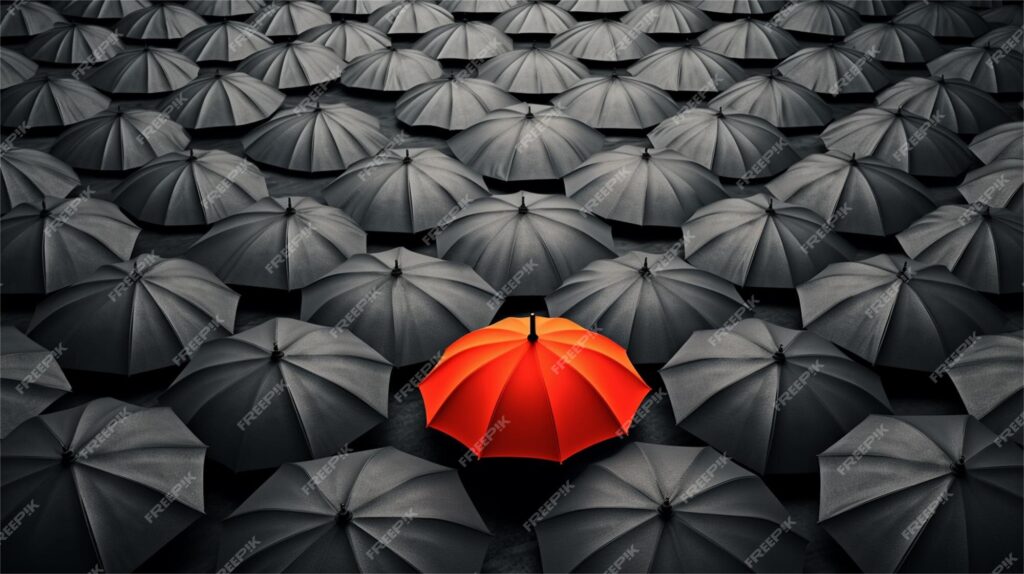 Red umbrella among many black umbrellas.